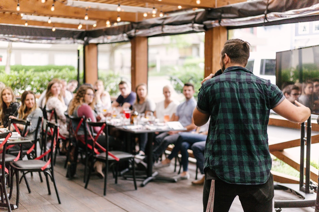 man-standing-infront-of-group-of-people-q7wgvnbuwj0